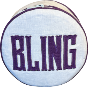 Round pouch with "BLING" embroidered in purple on a white background.