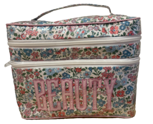 Floral-patterned beauty case with double zippers and "BEAUTY" embroidered on the front.