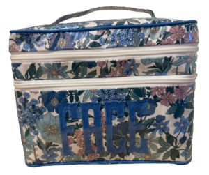 Floral-patterned bag with blue "FACE" lettering on the front and two zippered compartments.