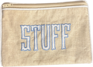 Natural and blue zip pouch with "STUFF" embroidered on the front.