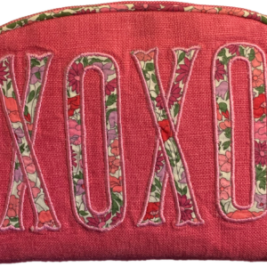 Pink pouch with floral "XOXO" embroidery on the front and a rounded top zipper.