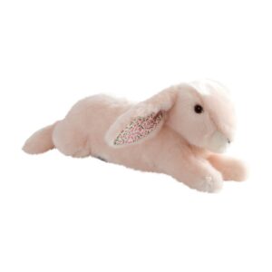 A soft, pink plush bunny with patterned ears lies on its stomach.