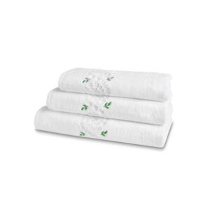 Three stacked white bath towels with green leaf embroidery.