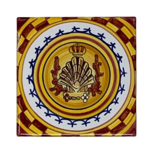 Ceramic tile featuring a shell design, crown, and decorative border in yellow and brown.