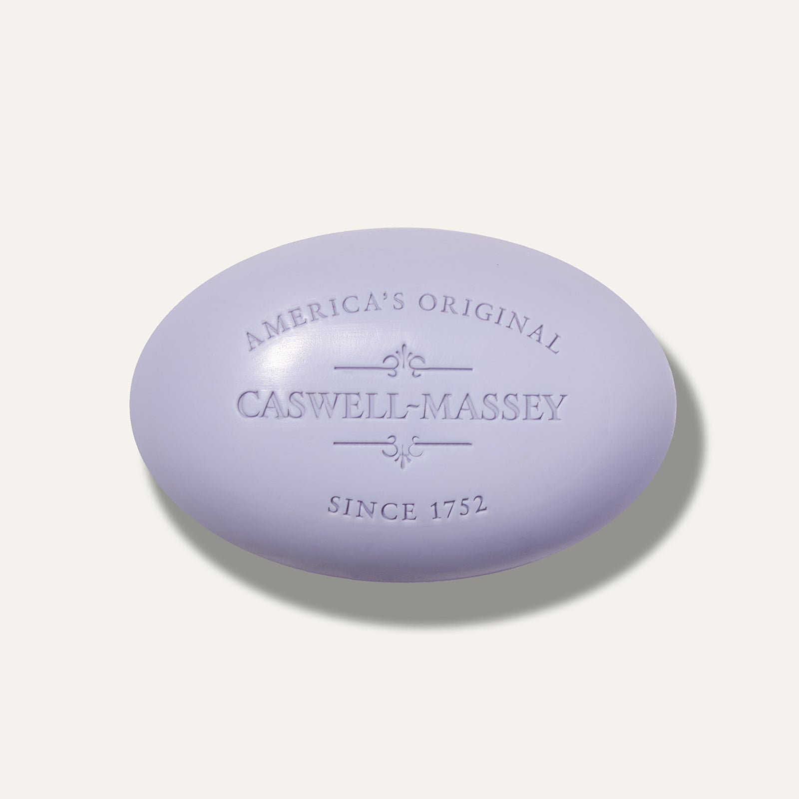Lavender bar soap with embossed text, featuring "Caswell-Massey" and "America's Original" since 1752.