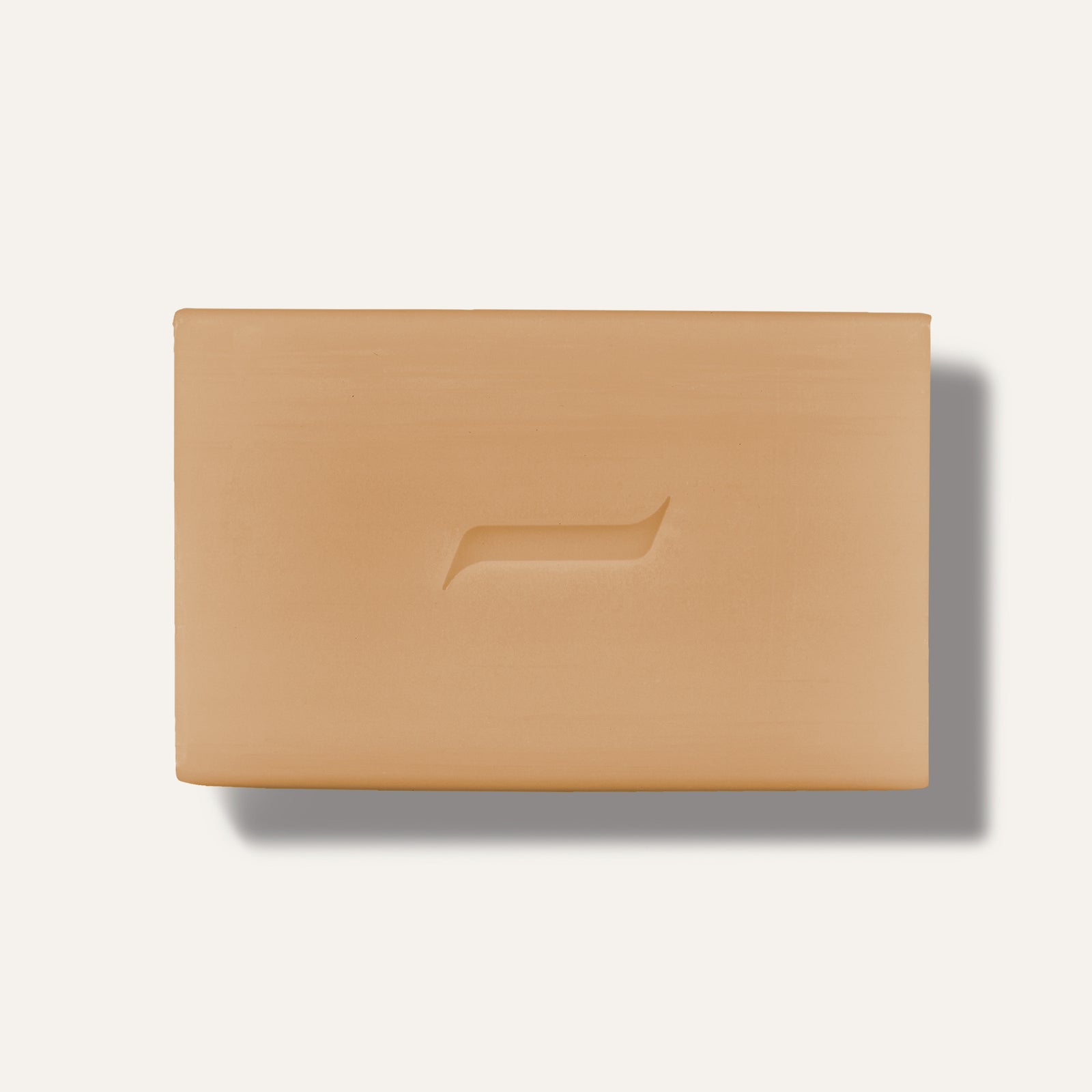 A rectangular oatmeal bar soap with a smooth surface and a subtle design on top.