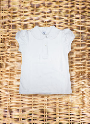 White short-sleeve polo shirt with a collar, laid flat on a woven surface.
