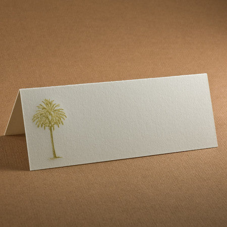A blank place card with a small palm tree illustration on one side.