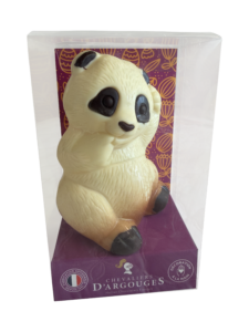 A chocolate panda figurine sits in a clear box with a decorative purple base.