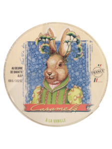 A whimsical rabbit in a colorful outfit surrounded by flowers, labeled "Caramels à la vanille.