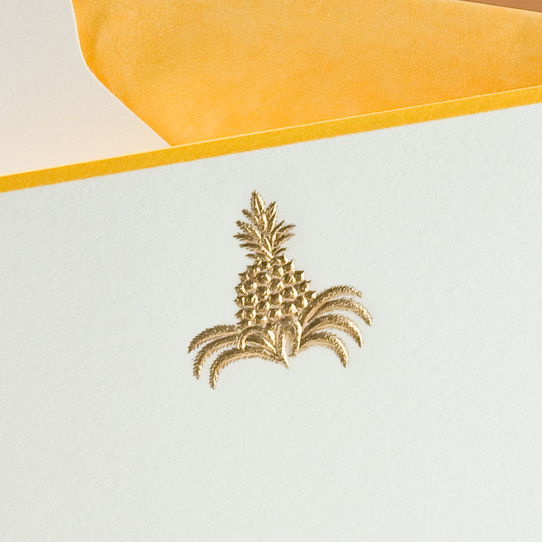 Gold-embossed pineapple design on a light blue note card with a yellow envelope.
