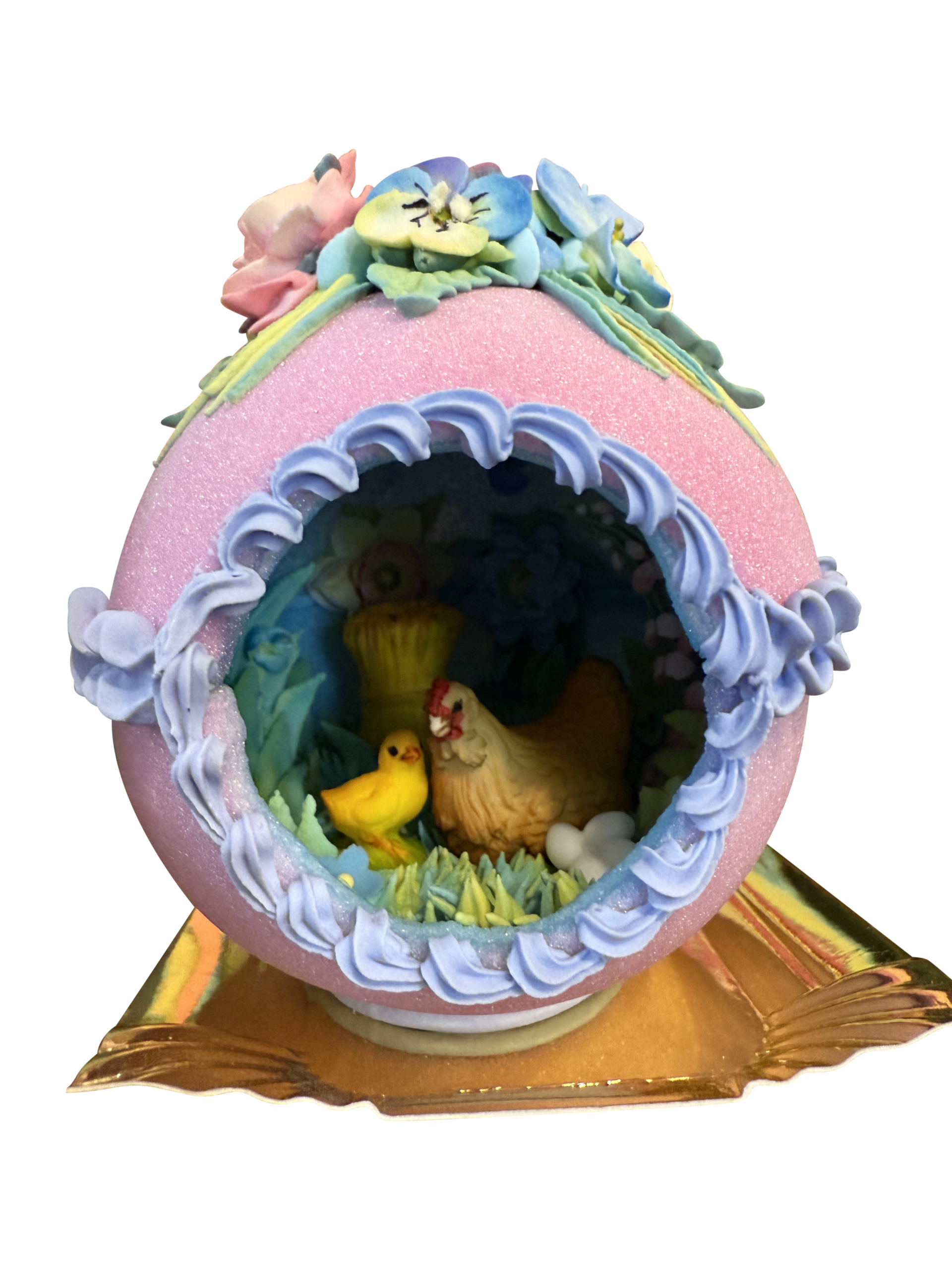 Sugar Egg Horizontal Hen and Chick A decorative sugar egg features a hen and chick inside, surrounded by pastel flowers and grass.