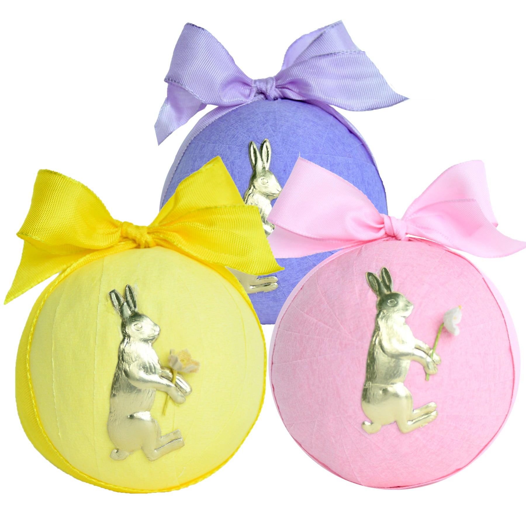 Three pastel-colored surprise balls with silver bunny decorations and ribbon bows.