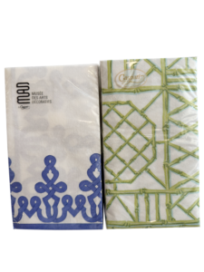 Two packs of Caspari guest towels with decorative designs in blue and green.