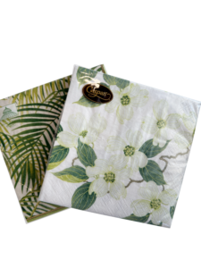 Two decorative napkins featuring floral and leaf patterns, with a Caspari logo on one.