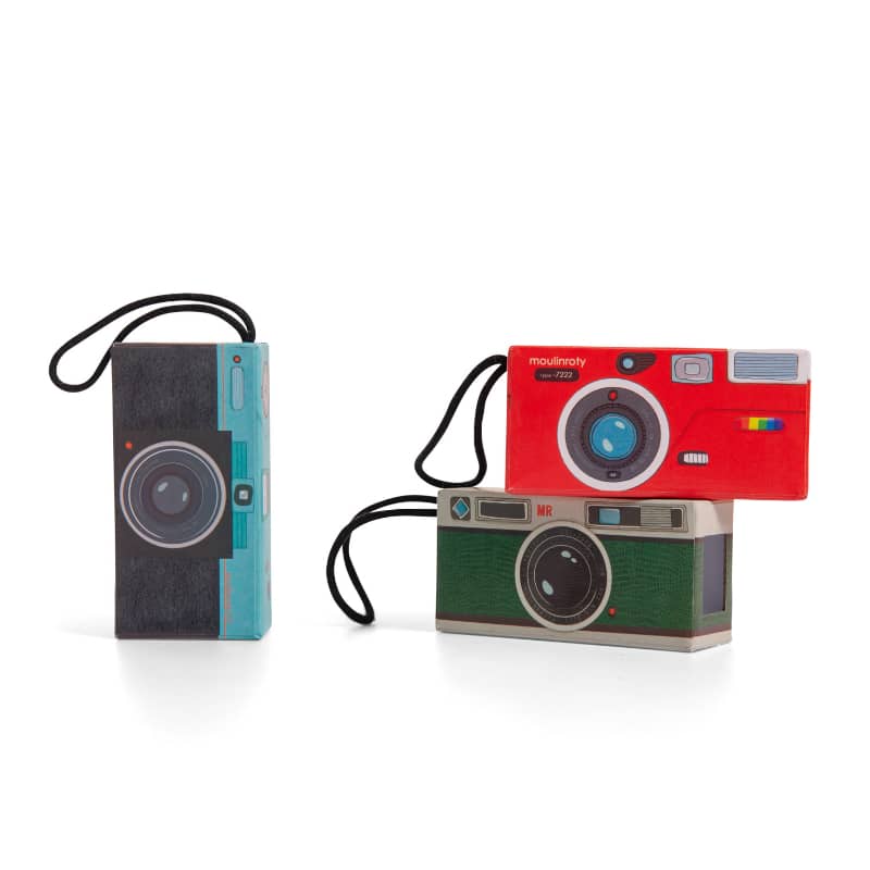 Three toy cameras in various colors and designs, stacked with straps attached.