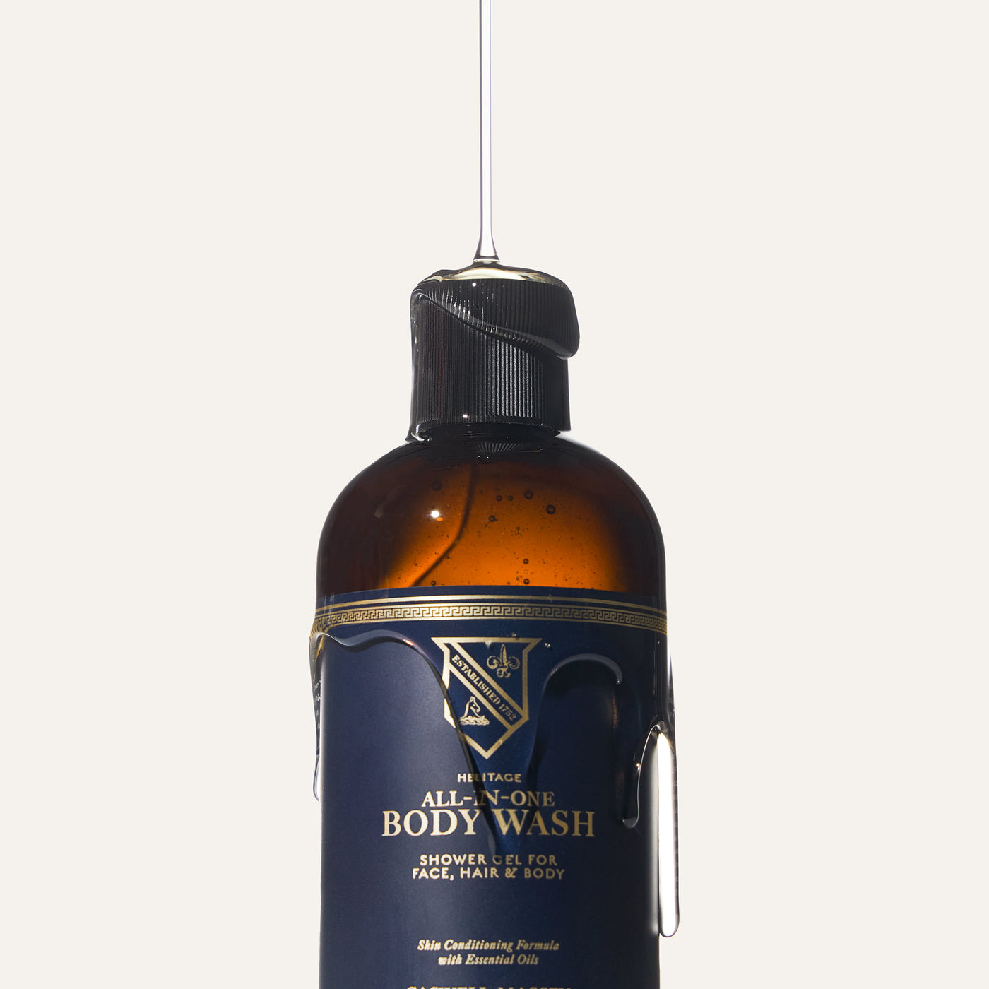 Brown bottle of all-in-one body wash with a black cap, labeled for face, hair, and body use.