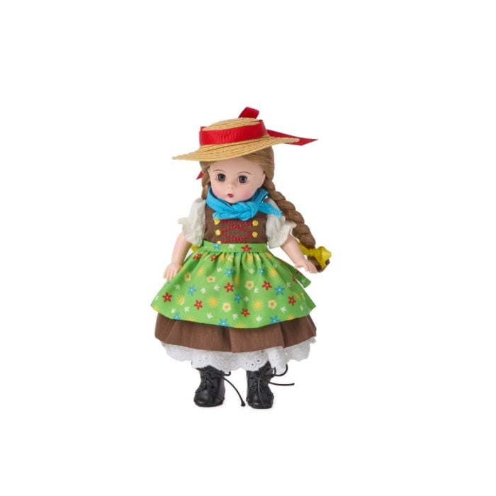 Doll wearing a colorful dress, blue scarf, and straw hat, with braided hair and black boots.