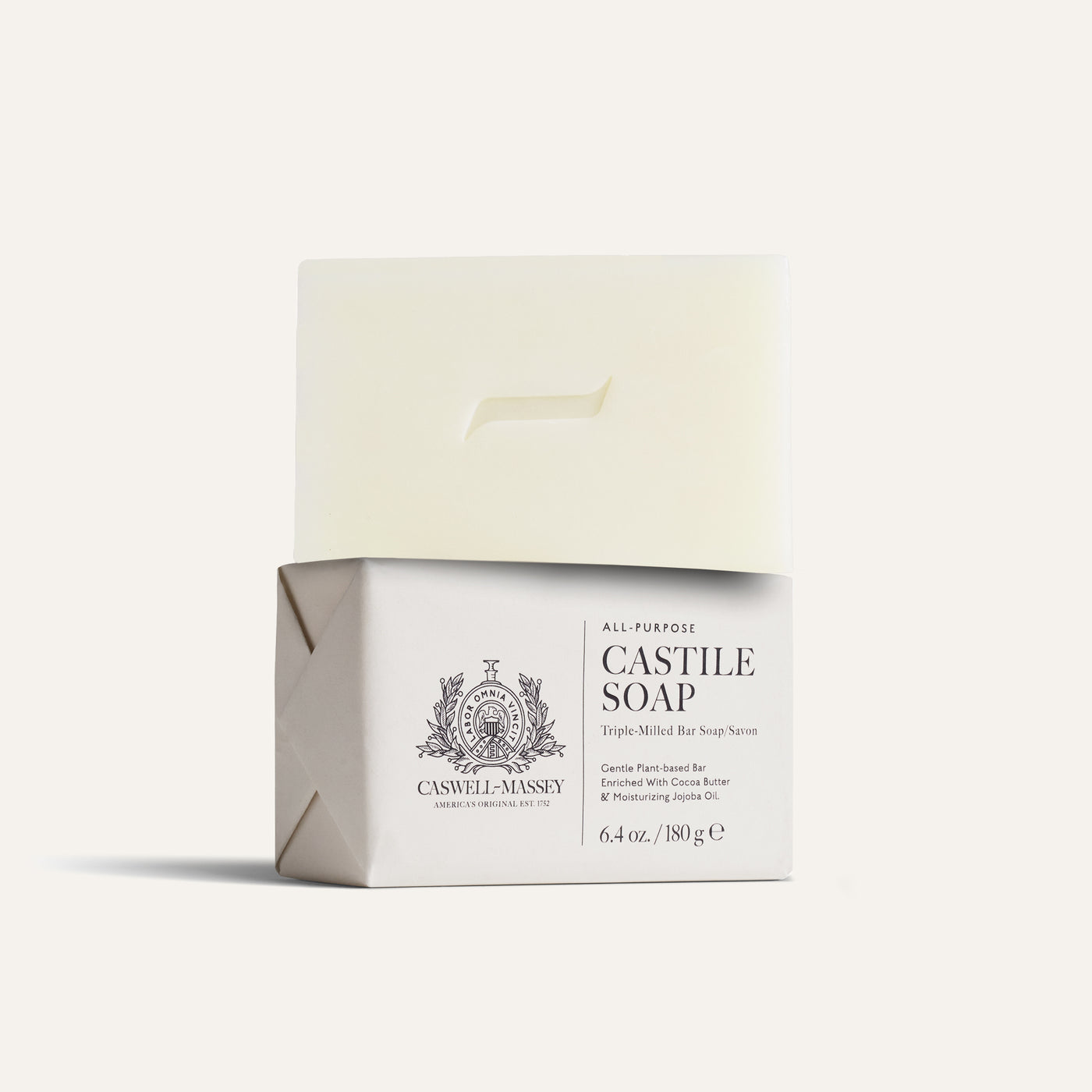A bar of Castile soap in a white and gray package, labeled with product details.