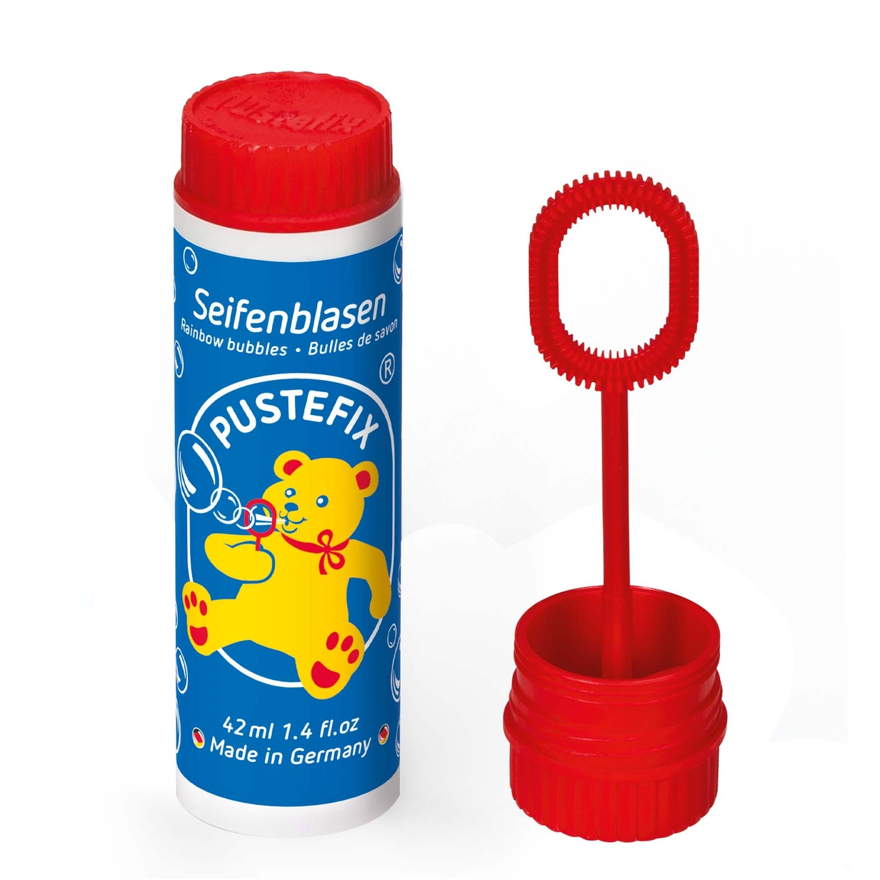 A bottle of bubble solution with a red cap and a bubble wand featuring a bear design.