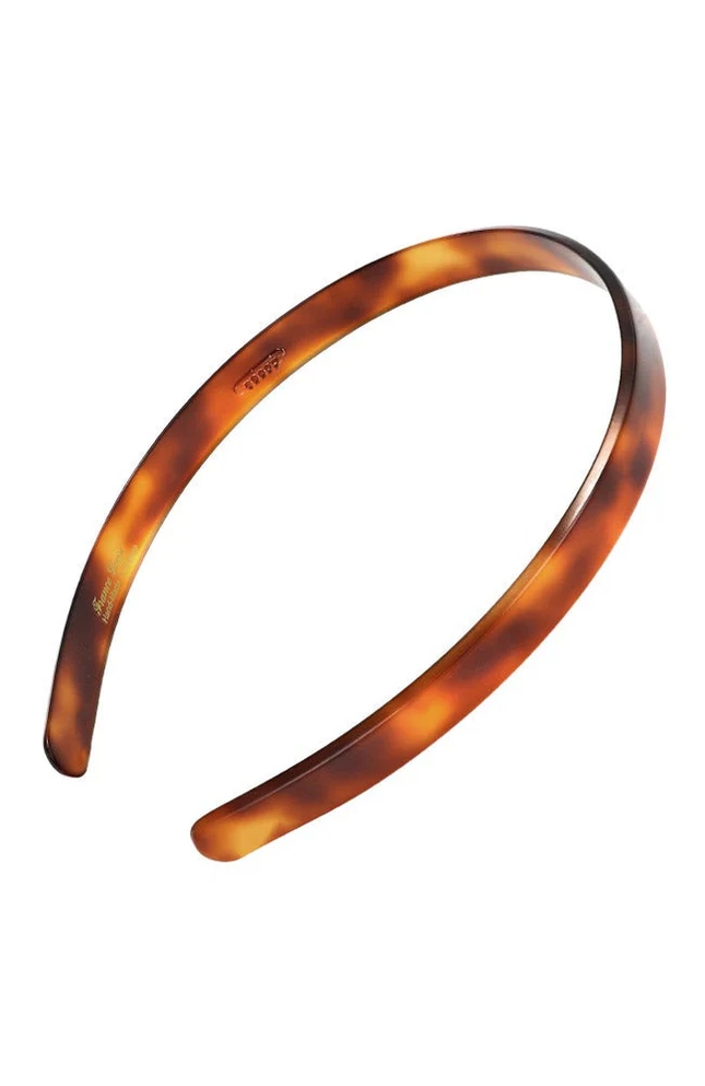 Tortoiseshell-patterned hairband with a smooth, glossy finish.