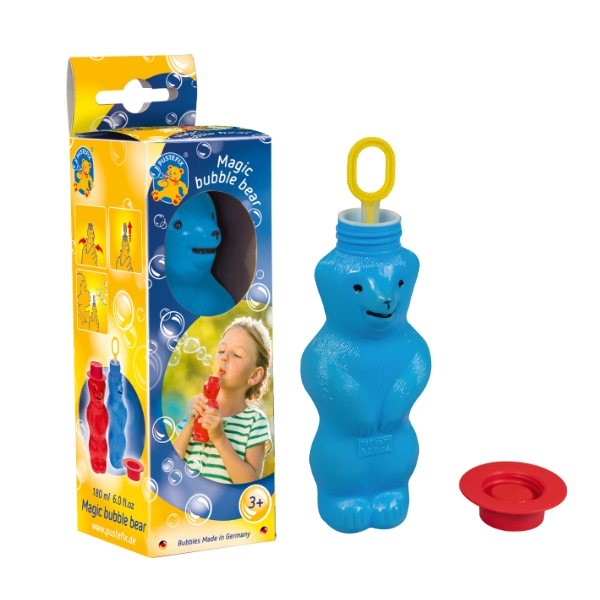 A blue bear-shaped bubble bottle next to a child blowing bubbles, with packaging in the background.