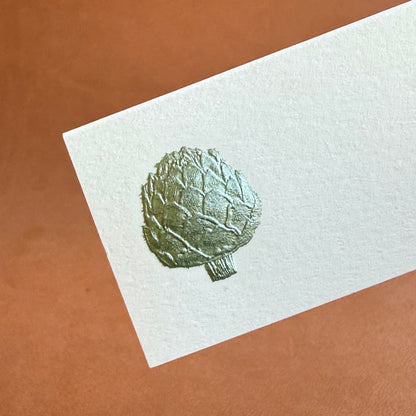 A textured place card featuring a green artichoke illustration on a light background.