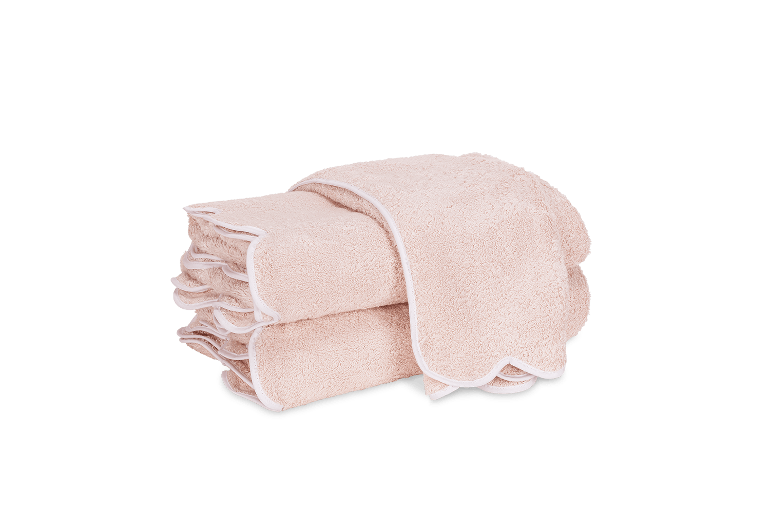 Stack of soft blush towels with scalloped edges and white trim.