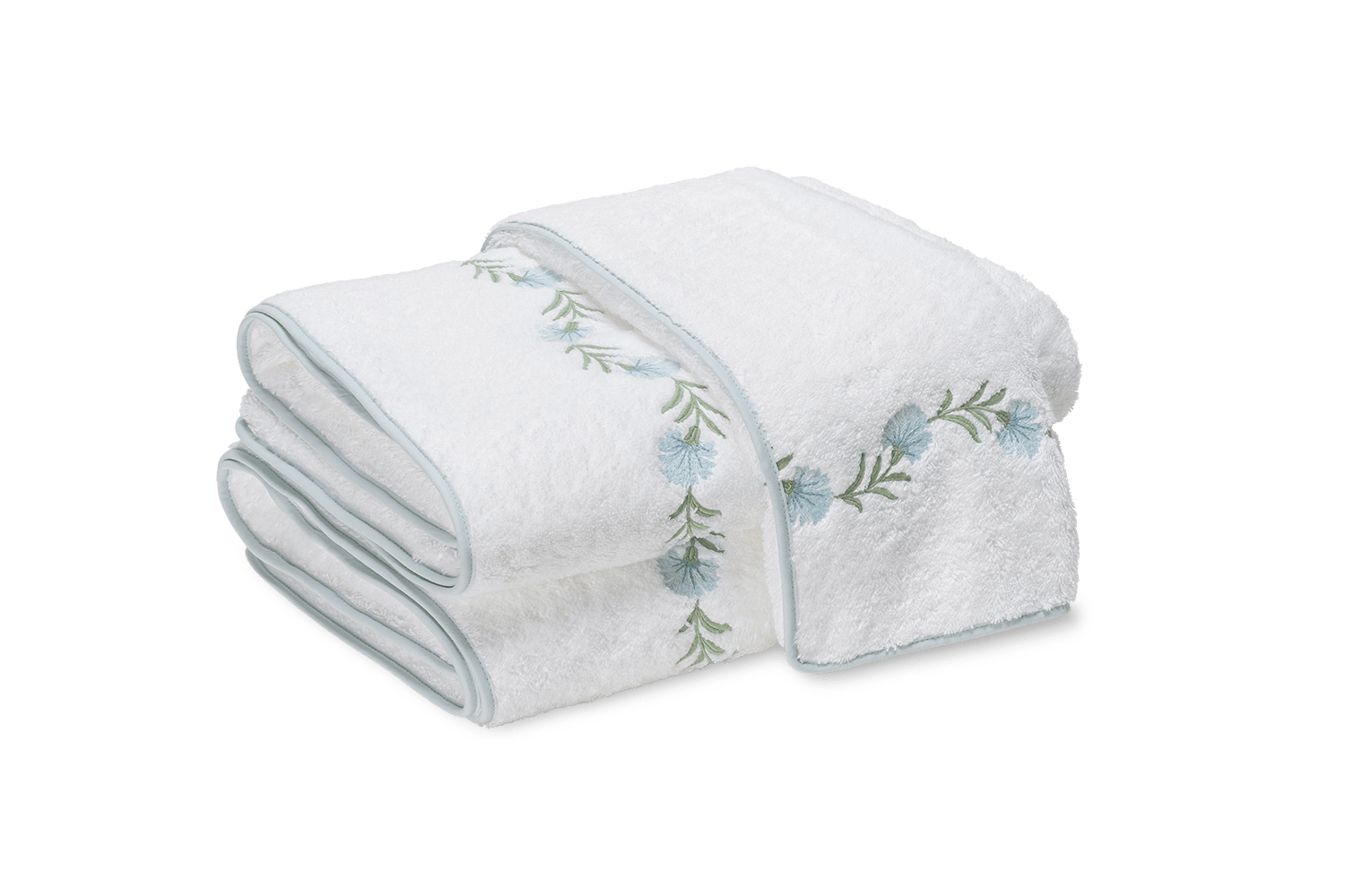 White towel neatly folded with blue floral embroidery along the edge.