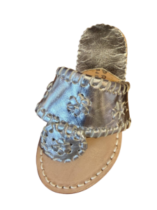 Silver sandals with decorative stitching and floral design on a light brown sole.